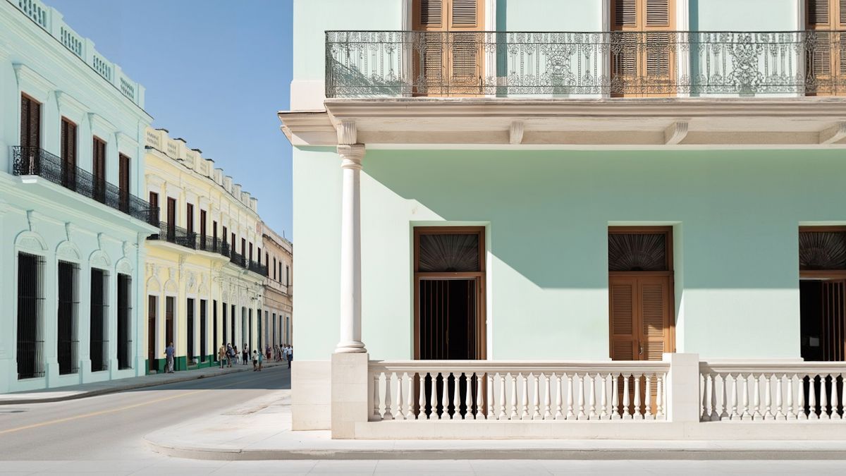 Pastel building with white balconies on a sunny street